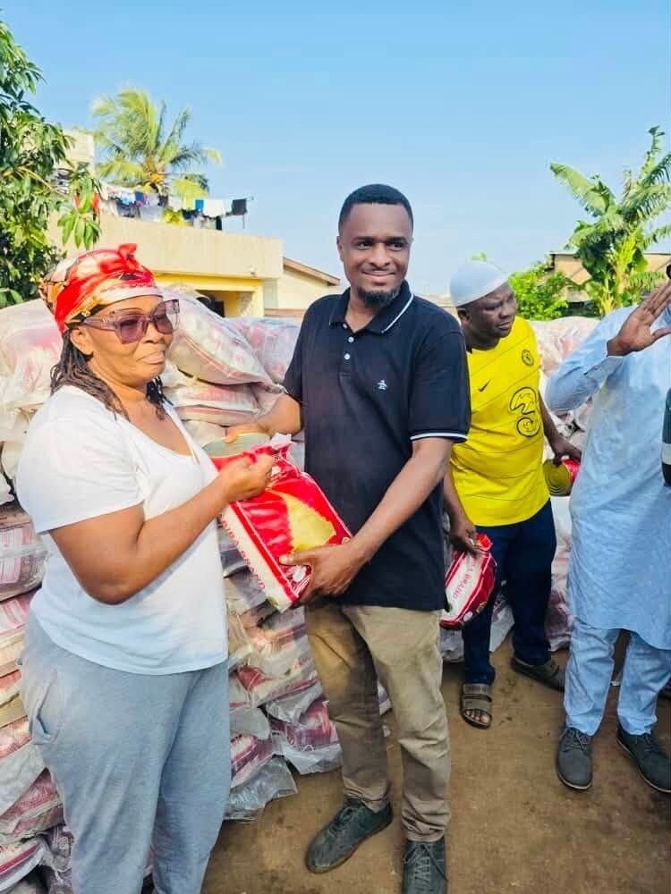 The MP presenting relief items to residents affected by the floods