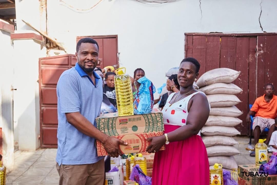 An Indomie vendor receiving a business support kit from the MP