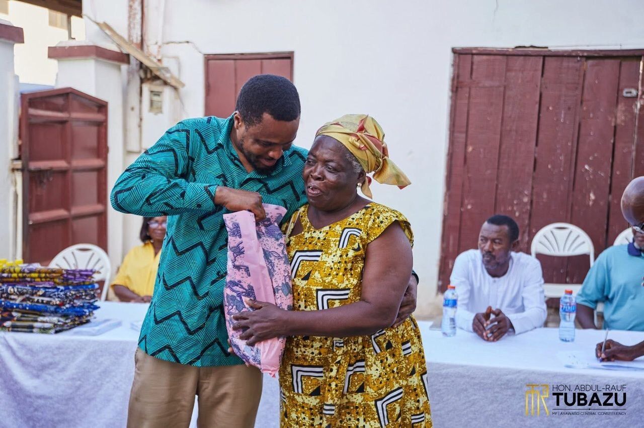 A widow receiving her cloth from the MP
